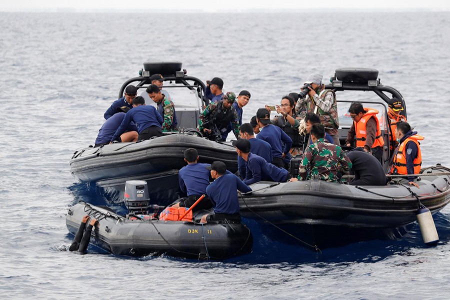 Rescue team members prepare to dive at the location where Lion Air flight JT610 crashed into the sea, in the north coast of Karawang regency, West Java province Indonesia on Tuesday — Reuters