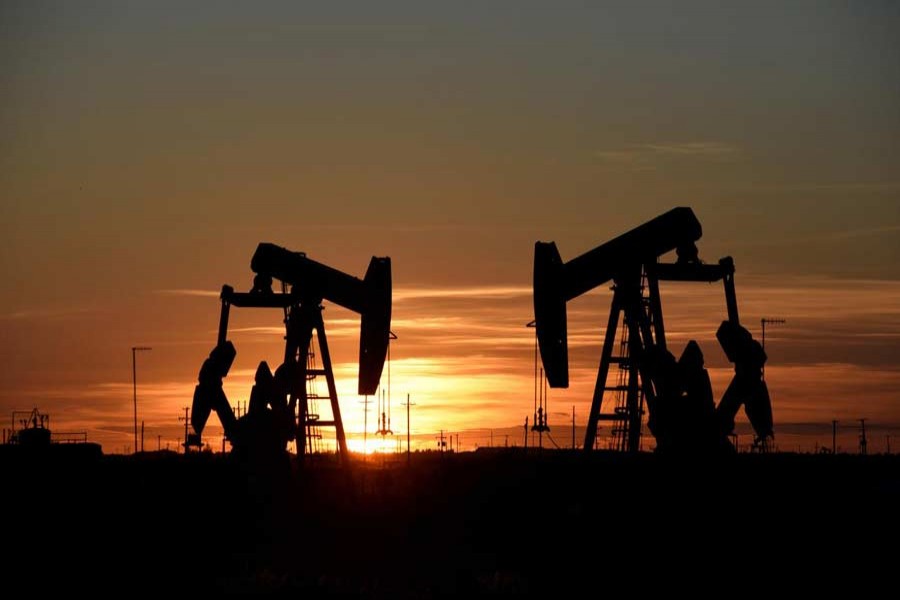 Pump jacks operate at sunset in an oil field in Midland, Texas, US, August 22, 2018. Reuters