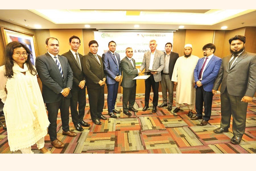 Dr. Ali Afzal, Chairman of Krishibid Feed Limited and Khairul Bashar Abu Taher Mohammed, CEO of MTB Capital Limited (MTBCL), exchanging documents after signing the agreement on behalf of the respective organisations at the Board Room of MTB Tower in the city. Under the agreement, MTB Capital Limited (MTBCL) will act as the Issue Manager and Corporate Adviser for capital raising and Initial Public Offering (IPO) of Krishibid Feed Limited.