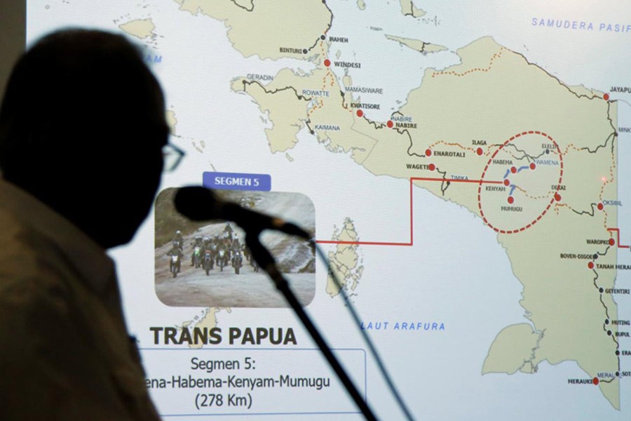 Indonesia's Minister of Public Works and Public Housing Basuki Hadimuljono showing a Papua map during a news conference on Tuesday. -Reuters Photo