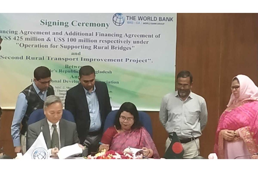 Mahmuda Begum, Additional Secretary of Economic Relations Divisions (ERD), and Quimiao Fan, World Bank Country Director for Bangladesh, Bhutan and Nepal, signing deals at ERD in the city on Thursday   -UNB photo