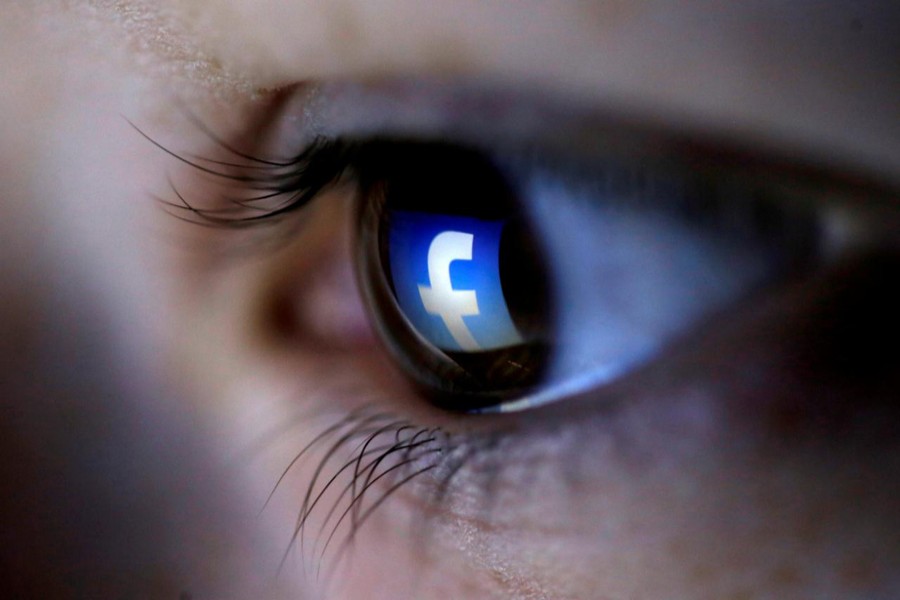 A picture illustration shows a Facebook logo reflected in a person's eye, in Zenica, March 13, 2015. Reuters/Files