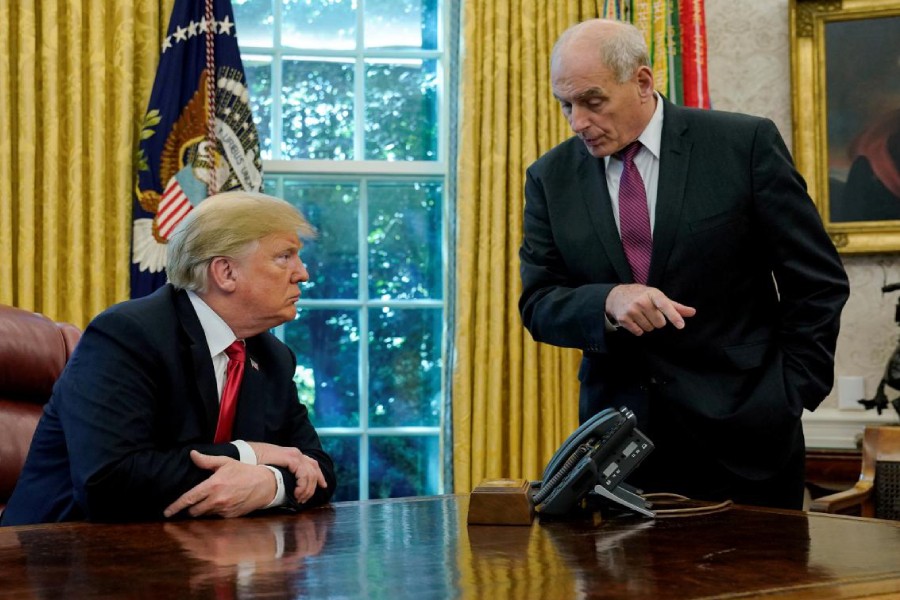 U.S. President Donald Trump speaks to White House Chief of Staff John Kelly after an event with reporters in the Oval Office at the White House in Washington, US October 10, 2018 - REUTERS/Jonathan Ernst/File Photo