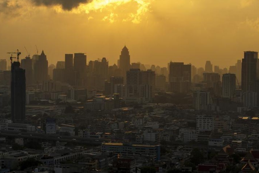 The skyline of central Bangkok is seen during sunrise in Bangkok April 22, 2015 - REUTERS/Athit Perawongmetha