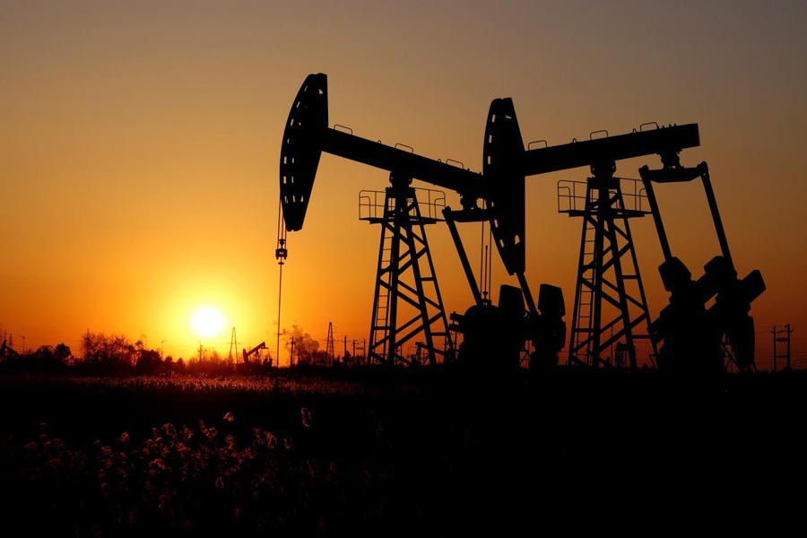 Pumpjacks are seen against the setting sun at the Daqing oil field in Heilongjiang province, China  	— Reuters