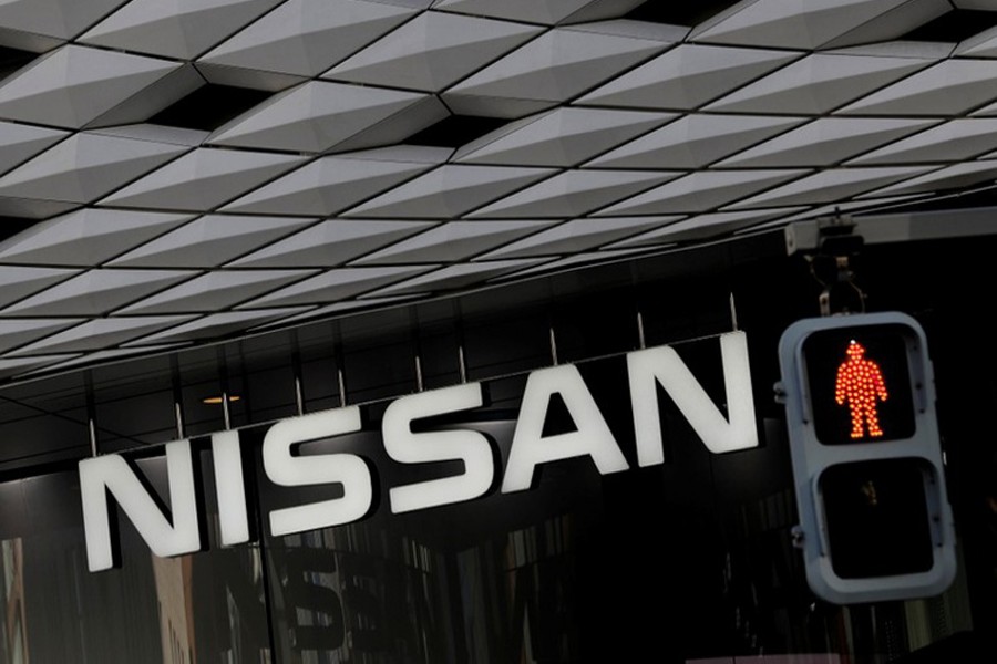 Nissan's signboard is seen behind a traffic sign at its showroom in Tokyo, Japan, December 14, 2018. Reuters