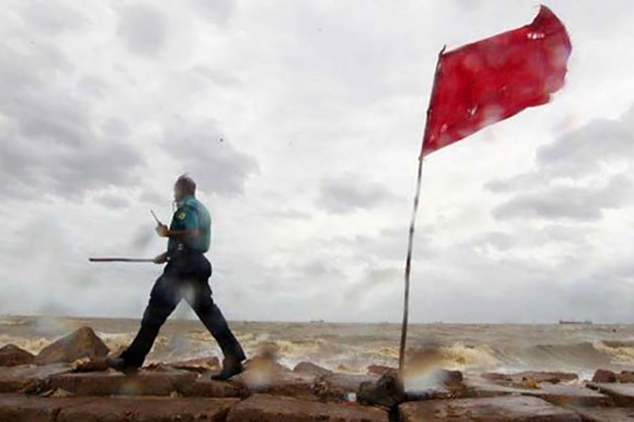 A policeman patrols near a port area ahead of bad weather. File photo