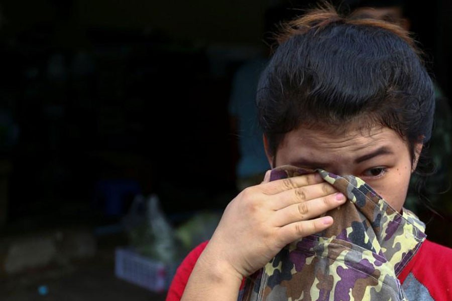 A migrant worker cries during a crack down on illegal migrant workers at a market in Bangkok, Thailand, September 27, 2016, Picture taken September 27, 2016 - REUTERS/Athit Perawongmetha