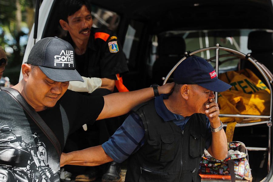 A man crying after identifying a relative during a rescue operation at the beach front hotel, which was hit by a tsunami in Pandeglang, Banten province in Indonesia on Monday. -Reuters Photo