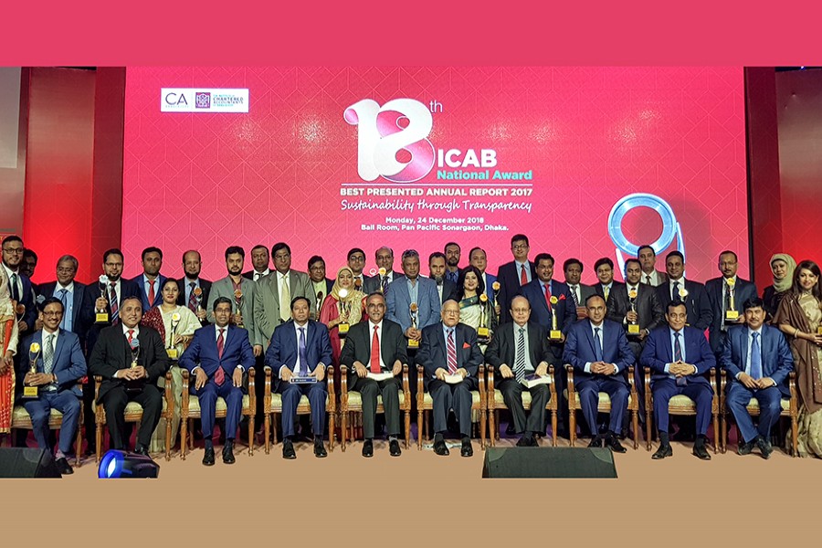 Finance Minister AMA Muhith with the representatives of the entities winning the awards of the Institute of Chartered Accountants of Bangladesh (ICAB) and others at the awards ceremony in the city on Monday — FE photo