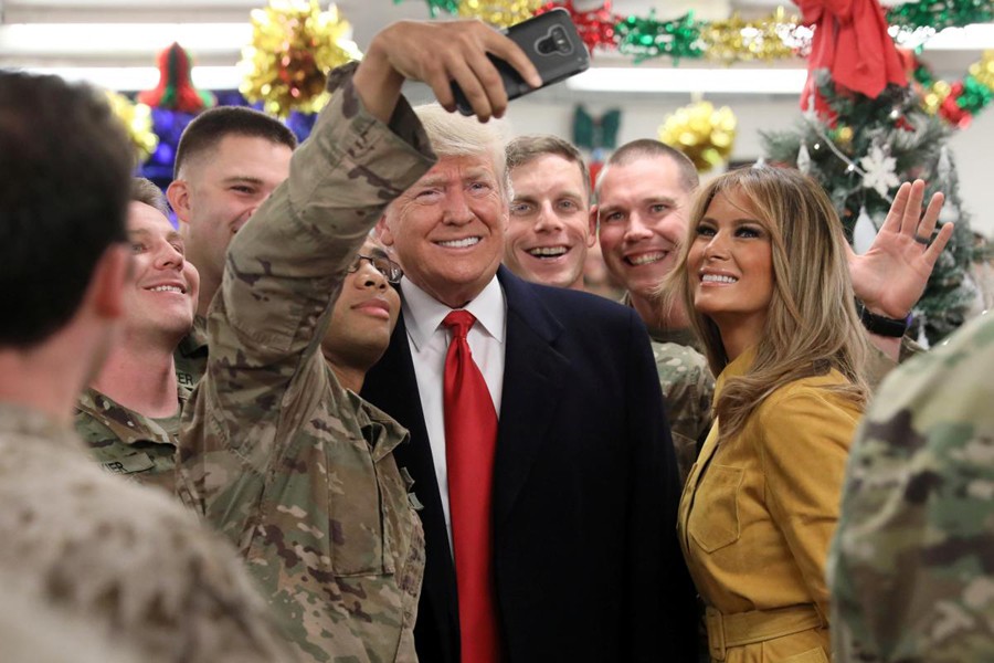 US President Donald Trump and First Lady Melania Trump greet military personnel at the dining facility during an unannounced visit to Al Asad Air Base, Iraq December 26, 2018. Reuters