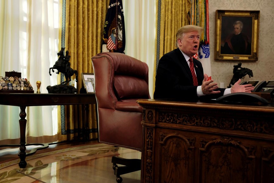 US President Donald Trump speaks with reporters after holding a video call with US military service members in the Oval Office on Christmas morning in Washington, December 25, 2018. Reuters/File Photo