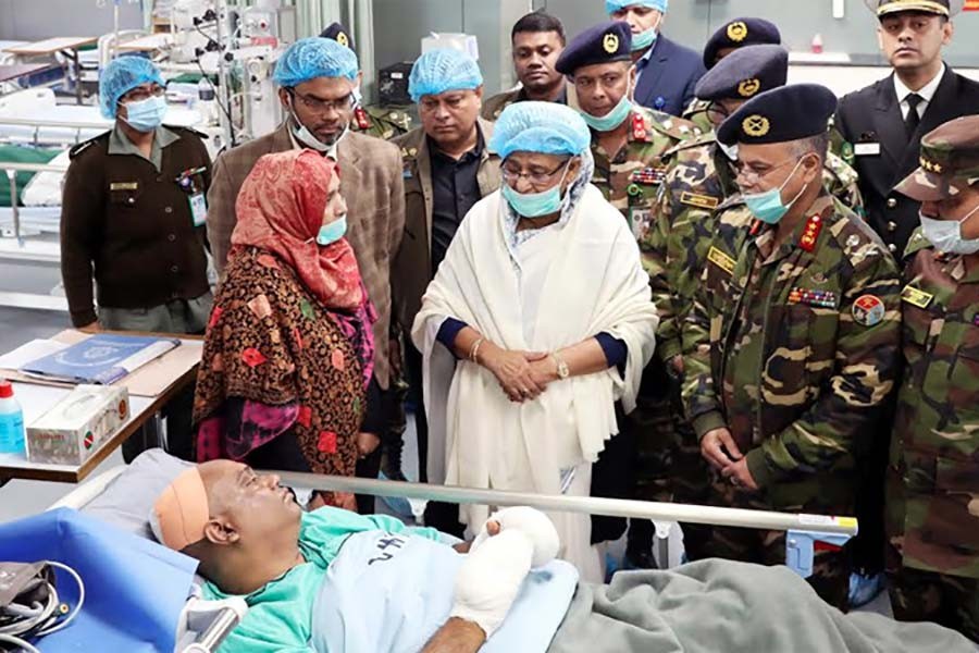 Prime Minister Sheikh Hasina visiting a wounded leader of Awami League at Dhaka Combined Military Hospital (CMH) on Saturday. -BSS Photo