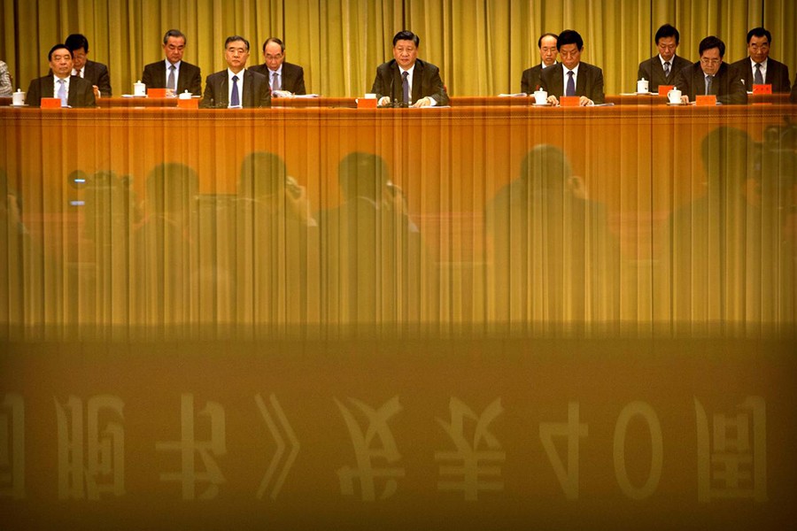 A banner is reflected on a polished surface as Chinese President Xi Jinping (C) speaks during an event to commemorate the 40th anniversary of the "Message to Compatriots in Taiwan" at the Great Hall of the People in Beijing, China on Wednesday — Reuters