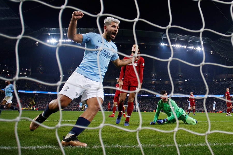 Manchester City's Sergio Aguero celebrates their second goal scored by Leroy Sane (not pictured) as Liverpool's Alisson and Virgil van Dijk cut dejected figures — Reuters photo