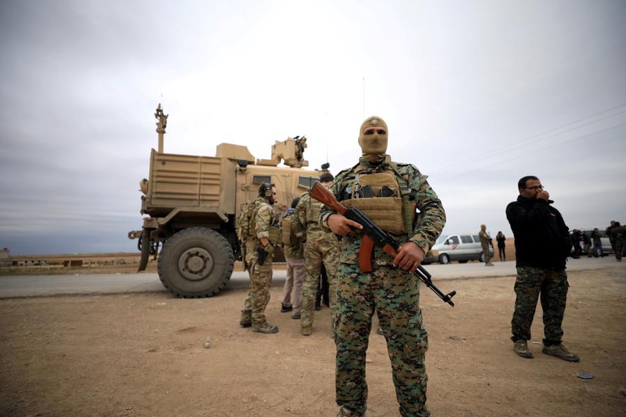 Syrian Democratic Forces and US troops are seen during a patrol near Turkish border in Hasakah of Syria   	—  Reuters  file