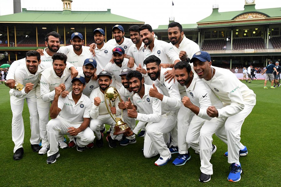 The Indian team pose for a photograph with the Border-Gavaskar Trophy as they celebrate a 2-1 series victory over Australia following play being abandoned in the fourth test match between Australia and India at the SCG in Sydney, Australia on Monday — Reuters photo