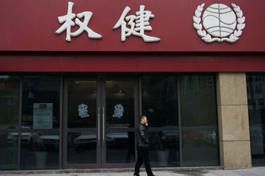 A man walks outside a branch of traditional Chinese medicine (TCM) firm Quanjian Group, in Hangzhou, Zhejiang province, China December 27, 2018 - REUTERS/Stringer