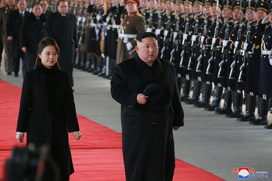 North Korean leader Kim Jong Un and wife Ri Sol Ju inspect an honour guard before leaving Pyongyang for a visit to China on Monday — KCNA photo via Reuters