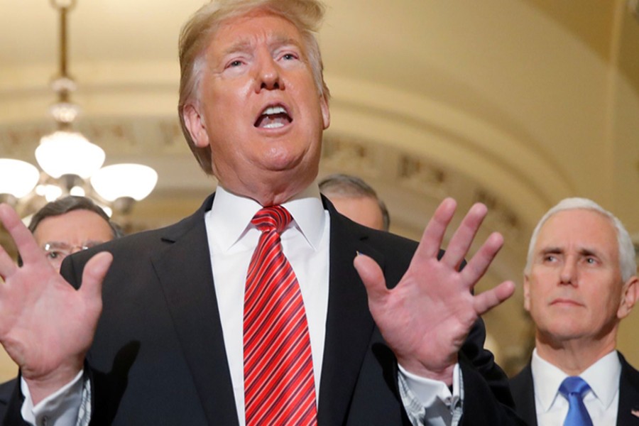 US President Donald Trump talks to reporters as Vice President Mike Pence looks on as the president departs after addressing a closed Senate Republican policy lunch while a partial government shutdown enters its 19th day on Capitol Hill in Washington, US, January 9, 2019. Reuters