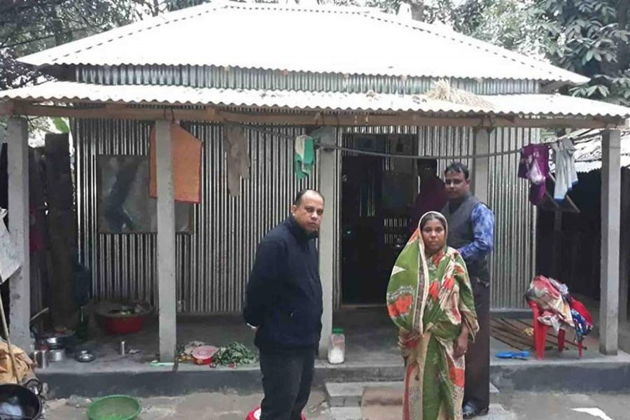 Project officials handing over a house to a family in Manda Upazila 	— FE Photo