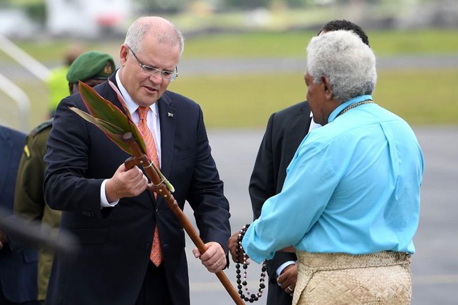 Australian Prime Minister Scott Morrison is presented with a gift as he arrives in Port Vila, Vanuatu, January 16, 2019 - AAP Image/Dan Himbrechts/via REUTERS