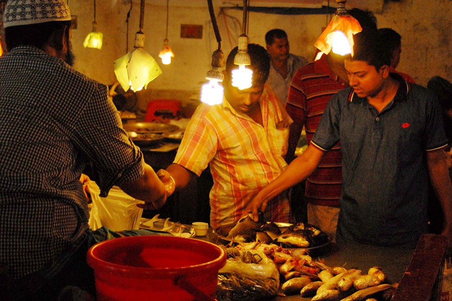 A potential customer seen bargaining fish prices at Plassey bazar in the capital Dhaka in this undated Focus Bangla photo