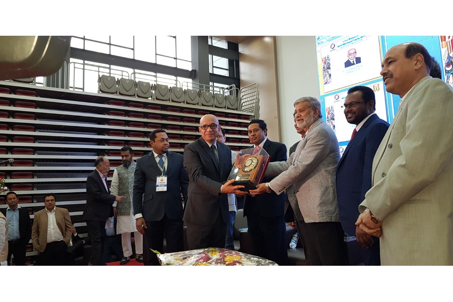 Planning Minister Muhammad Abdul Mannan handing over the ‘BGAPMEA Export Trophy-2018’ to Managing Director of Simtex Industries Ltd Md Siddiqur Rahman at ‘International Convention City Bashundhara (ICCB) in the city recently      