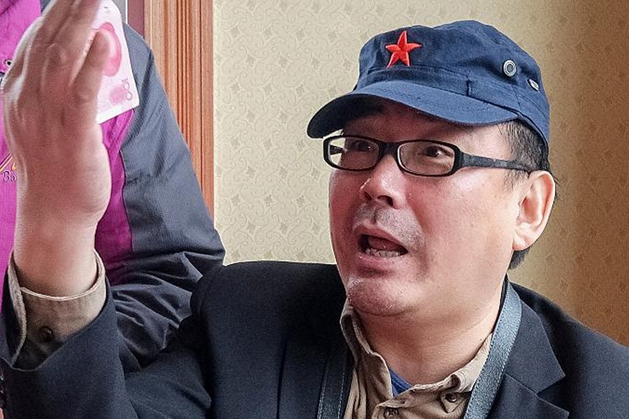 Yang Hengjun, author and former Chinese diplomat, who is now an Australian citizen, gestures in an unspecified location in Tibet, China, sometime in mid-July, 2014 in this social media image obtained by Reuters news agency