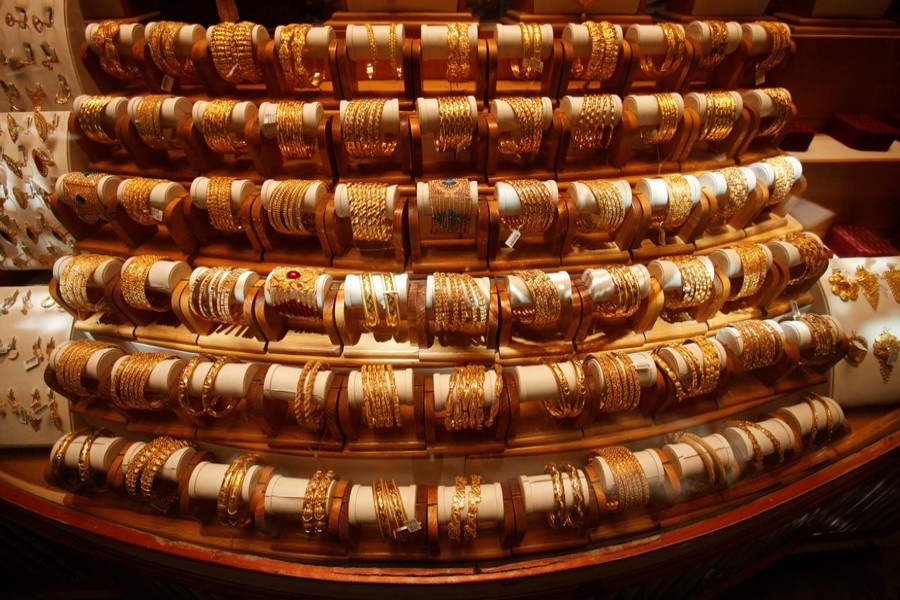 Sets of gold bangles are displayed in a showcase of a showroom selling bridal jewellery in Peshawar, Pakistan, May 9, 2018. Reuters/Files