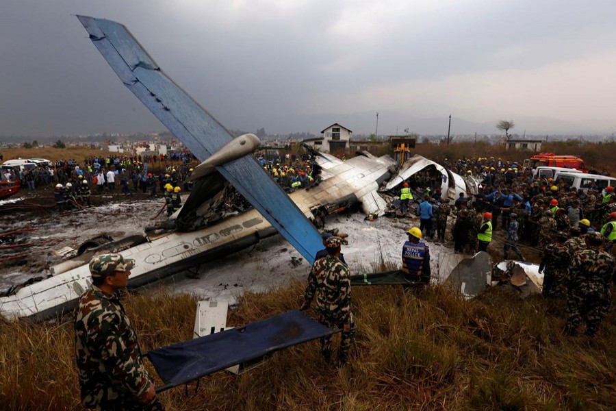 Rescue workers work at the wreckage of a US-Bangla airplane after it crashed at the Tribhuvan International Airport in Kathmandu, Nepal, March 12, 2018. Reuters/Files