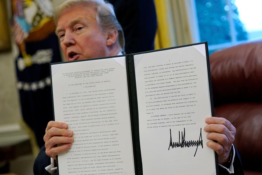 US President Donald Trump speaks to reporters after signing directives to impose tariffs on imported washing machines and solar panels before signing it in the Oval Office at the White House in Washington, US, January 23, 2018. Reuters