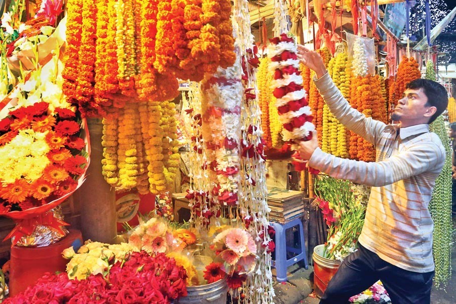 A seller arranging flowers at a shop in the city’s Shahbag area on Friday — FE Photo