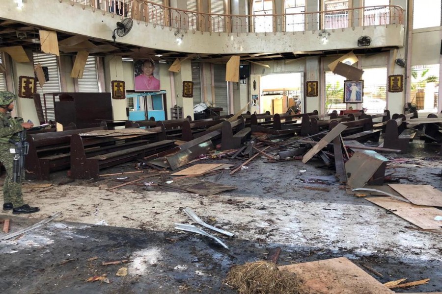 A Philippine Army member inspects the damage inside a church after a bombing attack in Jolo, Sulu province, Philippines January 27, 2019 - Reuters