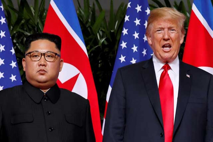 US President Donald Trump and North Korean leader Kim Jong Un react at the Capella Hotel on Sentosa island in Singapore, Jun 12, 2018. Reuters/File Photo