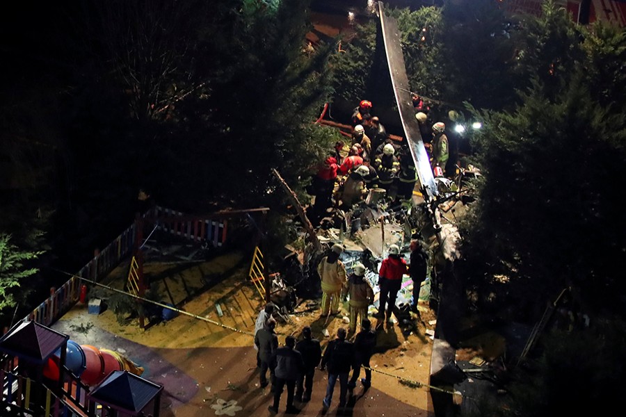 Firefighters and police inspect the site of a helicopter crash in Istanbul, Turkey on Monday — Reuters photo