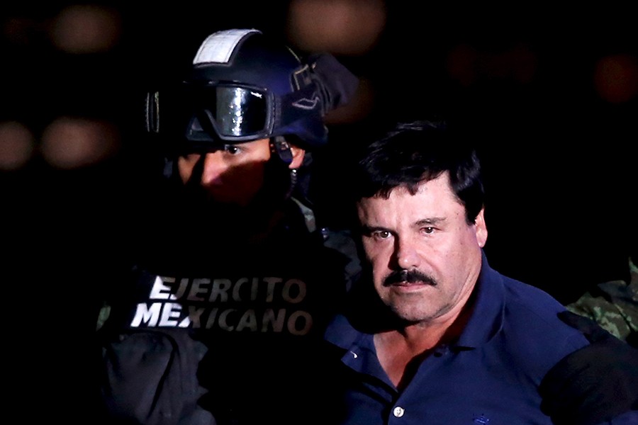 Joaquin "El Chapo" Guzman is escorted by soldiers during a presentation at the hangar belonging to the office of the Attorney General in Mexico City, Mexico on January 8, 2016 — Reuters/File