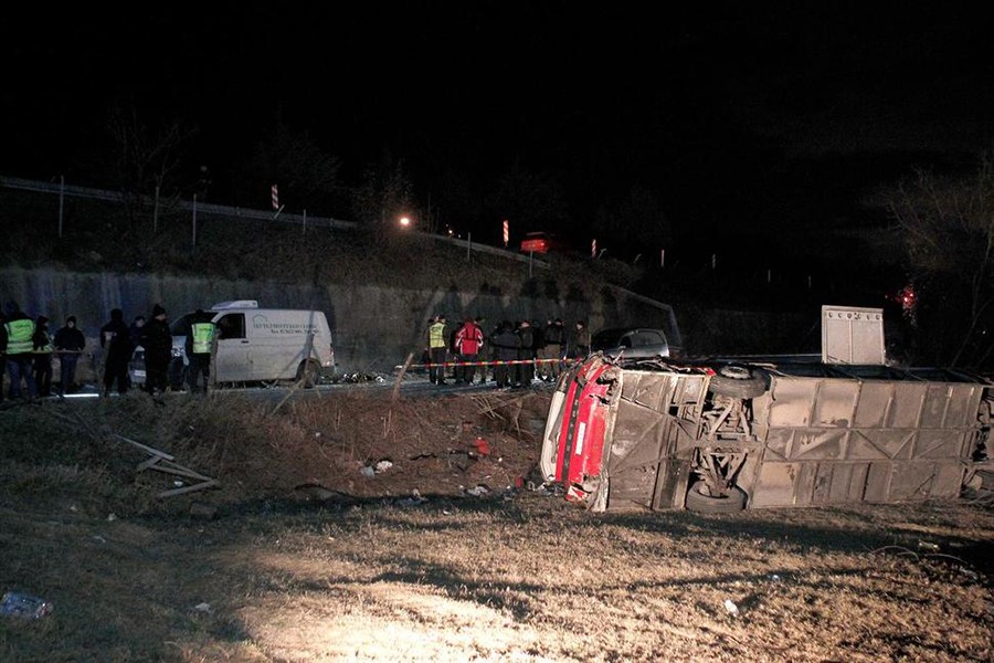 Police and investigators stand near the bus wreckage at the crash site at village of Laskarci, west of Skopje, North Macedonia on Wednesday — AP photo