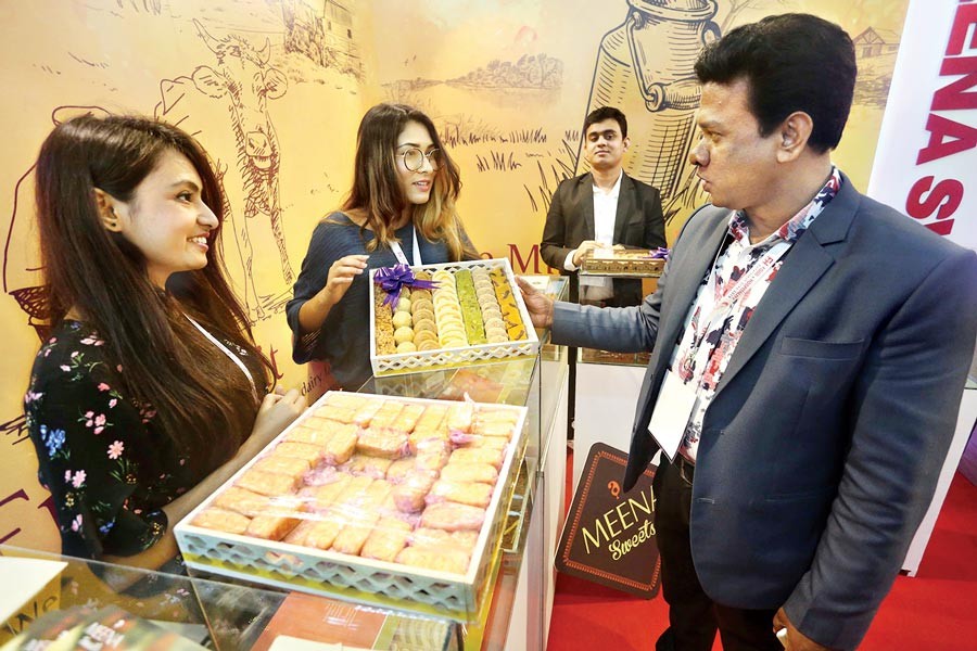 A visitor having a look at the sweetmeats at a stall at the three-day 'Food and Hospitality Bangladesh Expo 2019' that began at the International Convention City Bashundhara in the city on Thursday - FE Photo