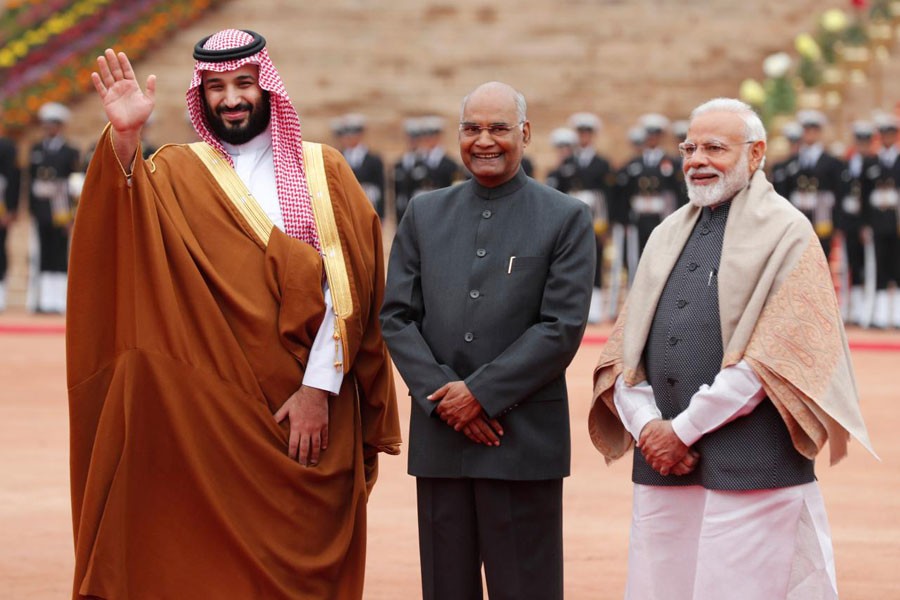 Saudi Arabia's Crown Prince Mohammed bin Salman waves next to India's President Ram Nath Kovind and Prime Minister Narendra Modi during his ceremonial reception at the forecourt of Rashtrapati Bhavan presidential palace in New Delhi, India, February 20, 2019 - REUTERS/Adnan Abidi