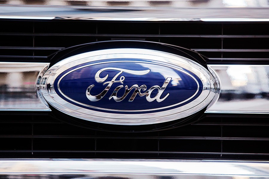 A Ford logo is seen on the grill of a 2015 F-150 truck outside — Reuters/File