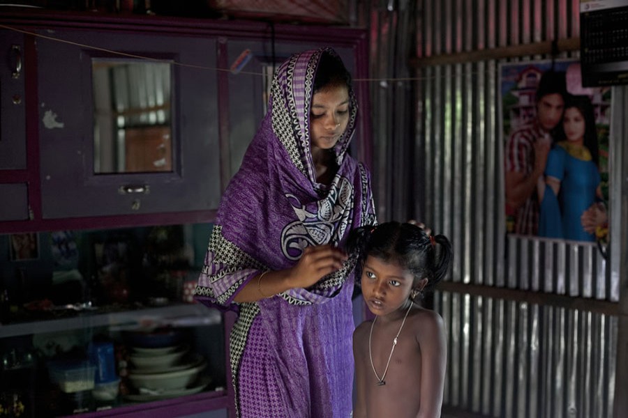 15-year-old Mousammat Akhi Akhter with her child. Photo: Collected