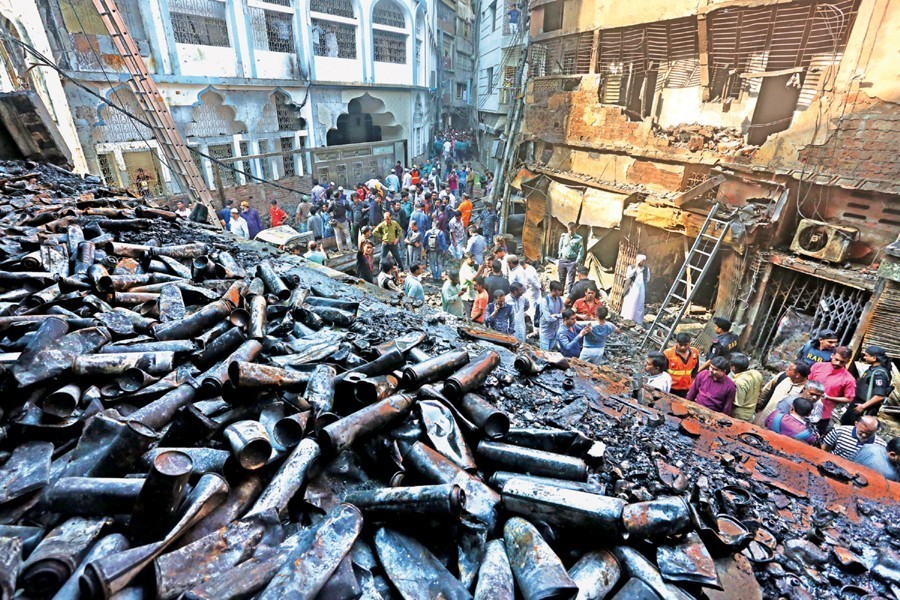 Charred refill cans of highly inflammable butane gas and perfumes lying on the first floor of a five-storey building at Churihatta of Chawkbazar in the city after Wednesday night's fire — FE photo/Files