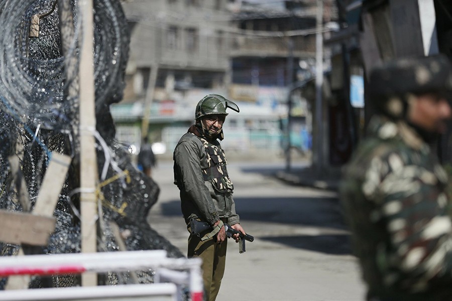 Indian paramilitary soldiers stand guard outside a closed market in Srinagar, India on Tuesday, March 5, 2019 — AP photo