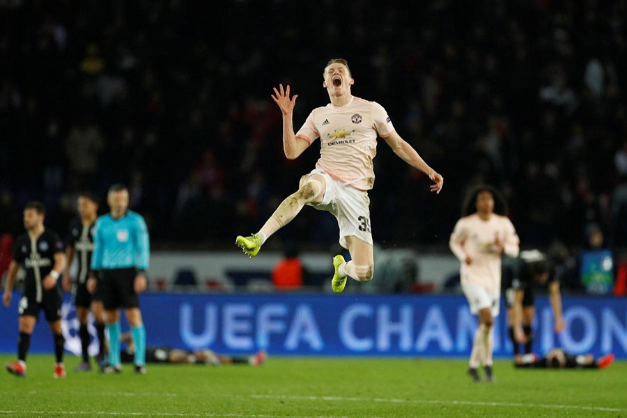 Manchester United's Scott McTominay celebrates wildly after pulling off a historic comeback against PSG — Reuters action image