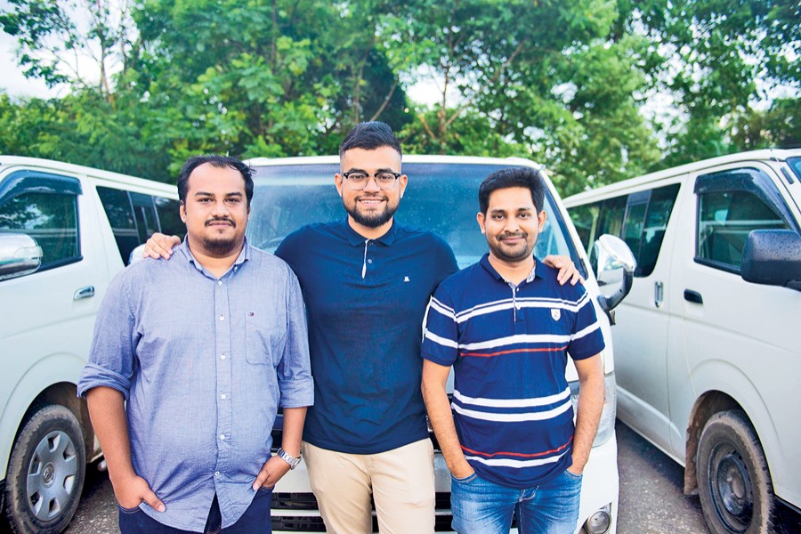 Founders of Shuttle, an app based transport service for professional women: Jawwad Jahangir (left), Reyasat Chowdhury (middle) and Shah Sufian Mahmud Chowdhury (right);  their Shuttle microbuses can be seen at the back