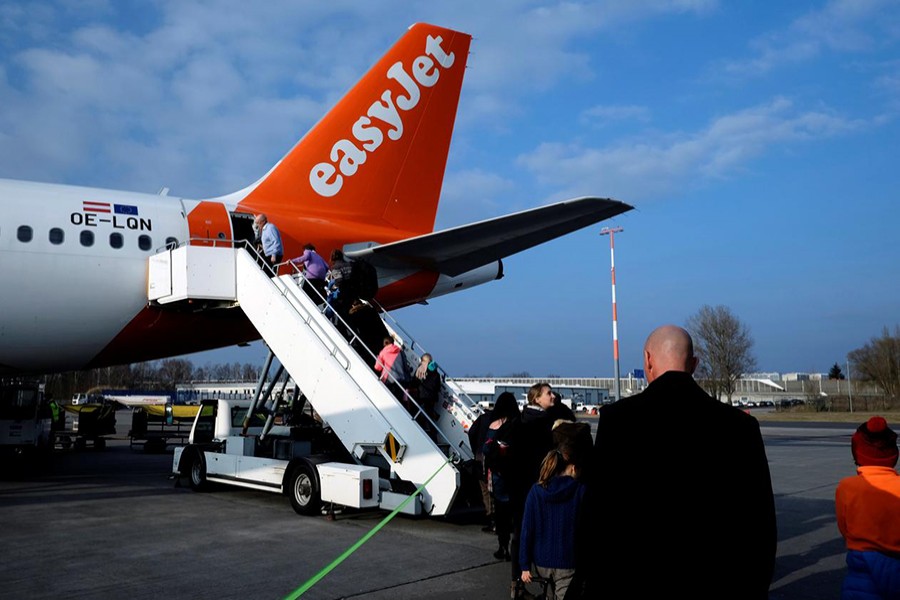 Passengers board the easyJet Airbus A319-111 OE-LQN aircraft from Berlin to Geneva at Schoenefeld airport near Berlin, Germany on March 24, 2018 — Reuters photo