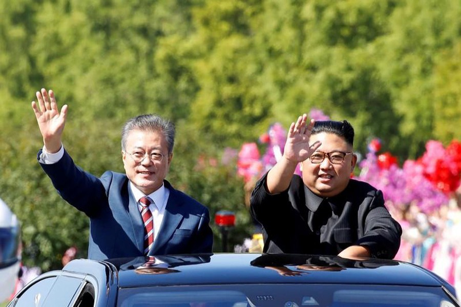 A file photo showing South Korean President Moon Jae-in (left) and North Korean leader Kim Jong Un waving during a car parade in Pyongyang, North Korea recently	— Reuters