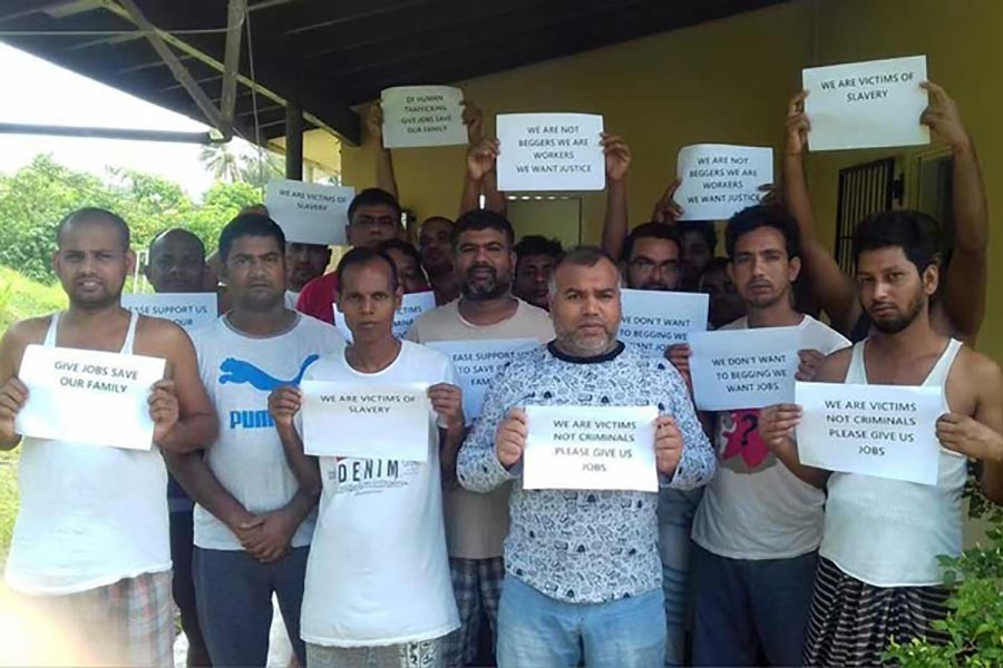 Bangladeshi migrant workers hold signs requesting help and support after they are stranded in Vanuatu. Photo credit: Vanuatu Daily Post via bdnews24.com