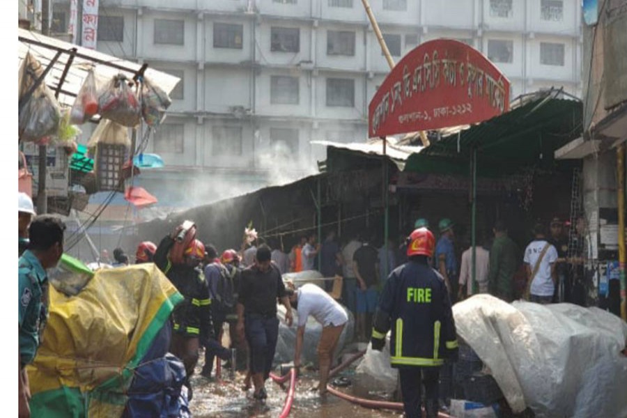 Firefighters and others dousing the fire at the Gulshan DNCC kitchen market fire on Saturday morning